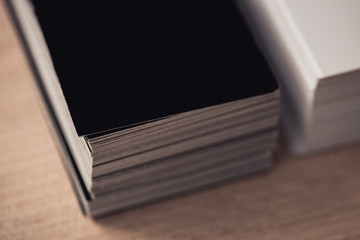selective focus of black and white business cards stacked on wooden surface