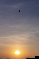 Airplane taking off or landing during sunset