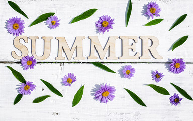 The word summer on a white wooden rustic background. Summer flat lay composition