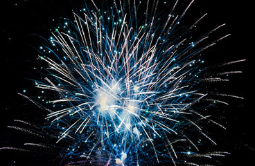 Obraz premium Colorful fireworks in the sky on black background. Celebratory salute, fireworks