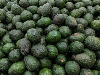 Fresh avocado as a background for sale in the supermarket