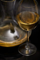 A glass full of wine and wine decanters
