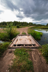 Little makeshift bridge over the river Inya. Western Siberia