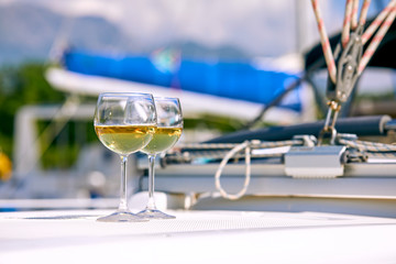 Fototapeta premium Pair of wineglasses against the yacht