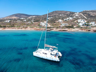 Catamaran sailing in  blue, turquoise water in Greece, beautiful catamaran next to the coast during summer holiday - obrazy, fototapety, plakaty