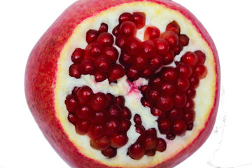 Juicy ripe pomegranate on white background. Pomegranate seeds