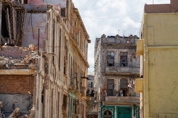 View of the broken and demolished residential homes in the Old Havana City, Capital of Cuba, during a cloudy and sunny day.