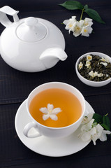 Green tea with jasmine in cup and teapot