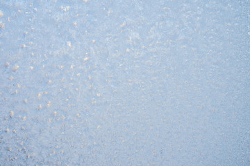 The patterns made by the frost on the window. Frosty winter background photo