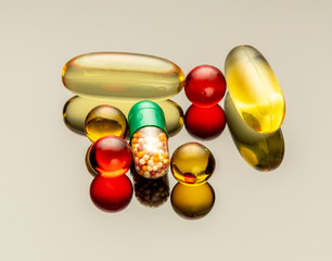 Multi-colored drugs and pills. Macro photo with reflection