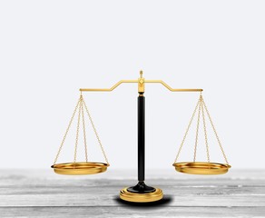 Golden law scales on table background. Symbol of justice