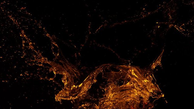 Super slow motion of splashing cola/whiskey/tea isolated on black background. Filmed on very high speed camera, 1000 fps.