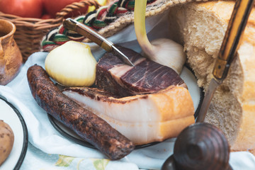 Onions, bacon and homemade sausage on the table