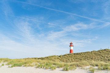 Fototapeta na wymiar Lighthouse red white on dune.