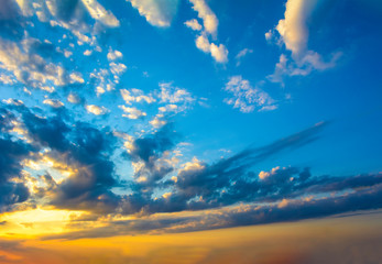Blue yellow sunny sky and clouds background of dramatic cloudscape and skyscape with clouds in sunset
