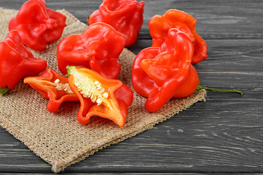 Ripe Chili Peppers on wooden background. Capsicum baccatum.