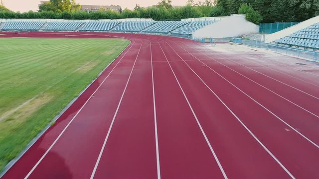 Flying over running track at stadium. Reaching goal and winning. Sport motivation