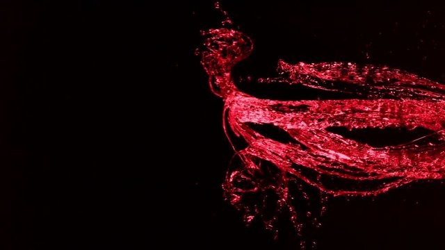 Super slow motion of splashing red wine on black background. Filmed on high speed cinema camera, 1000fps.