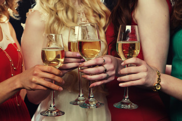lifestyle, party and people concept - Group of partying girls clinking flutes with sparkling wine