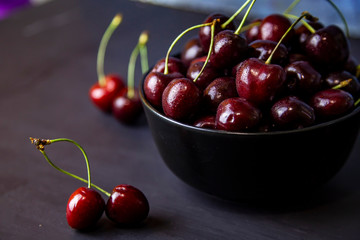 cherries in black containers on the table