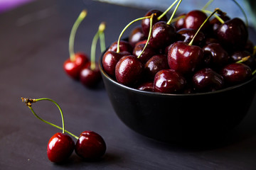 cherries in black containers on the table
