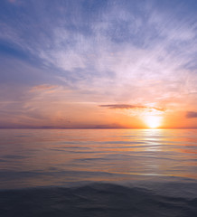 Sunset and sea with small waves.