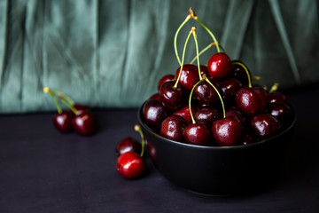 cherries in black containers on the table
