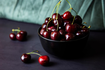 cherries in black containers on the table