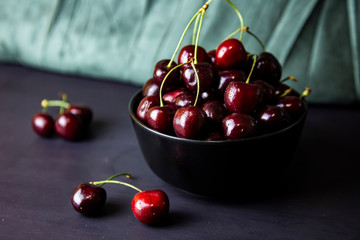 cherries in black containers on the table