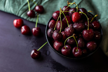cherries in black containers on the table