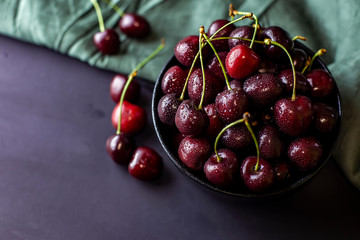 cherries in black containers on the table