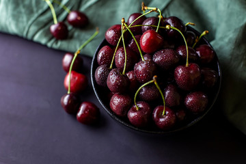 cherries in black containers on the table