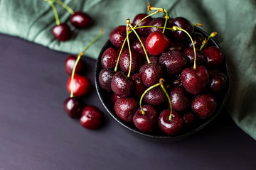 cherries in black containers on the table