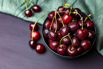 cherries in black containers on the table