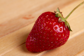 Close-up fresh strawberry isolated on wooden background.
