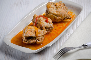 Chakhokhbili, traditional Georgian dish of stewed chicken, tomato and pepper with fresh herbs on wooden background