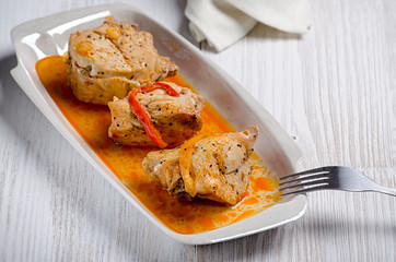 Chakhokhbili, traditional Georgian dish of stewed chicken, tomato and pepper with fresh herbs on wooden background