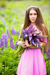 beautiful girl on lupine field