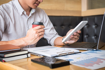 Businessman working investment project on laptop computer with report document and analyze, calculating financial data on graph documents, doing finance making statistics