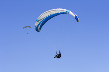Paragliding in the blue sky as background extreme sport