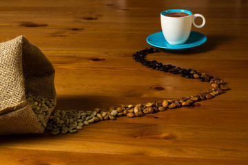 Different roasts of coffee beans from green to dark leading ot a cup of espresso