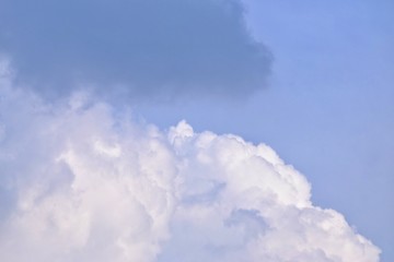 White dark fluffy clouds against blue sky for background texture 