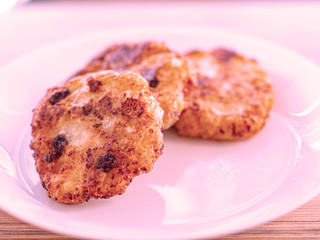 beautiful fried cheesecakes lie on a white plate sprinkled with powdered sugar