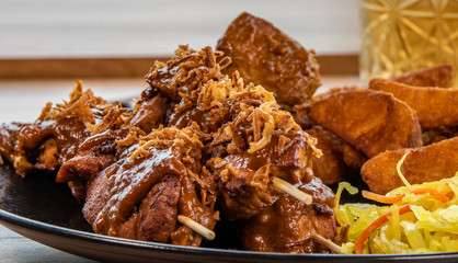 Plate saté menu with potatos closeup