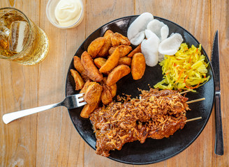 Plate saté menu with potatos above