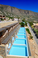 Swimming pool at luxury hotel with a view on Spinalonga Island, Crete, Greece