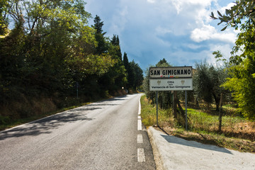 Hiking on a road at the entrance to the city of San Gimignano in Tuscany, Italy