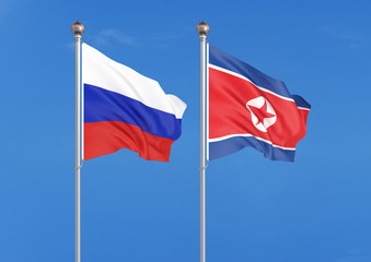 Russia vs North Korea. Thick colored silky flags of Russia and North Korea. 3D illustration on sky background. – Illustration