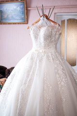 Fototapeta na wymiar White wedding dress of the bride
