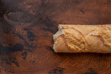 french baguette on textured wooden background